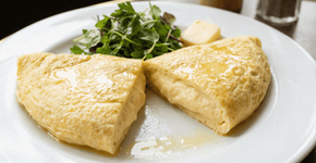 A omelete não é feita com leite; são necessários 3 ovos em temperatura ambiente, 1 colher de manteiga e 30 segundos em fogo médio-alto sem mexer