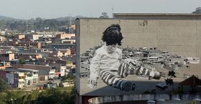 Usando fuligem, Alexandre Orion cria mural gigante de criança destruindo casas no Grajaú
