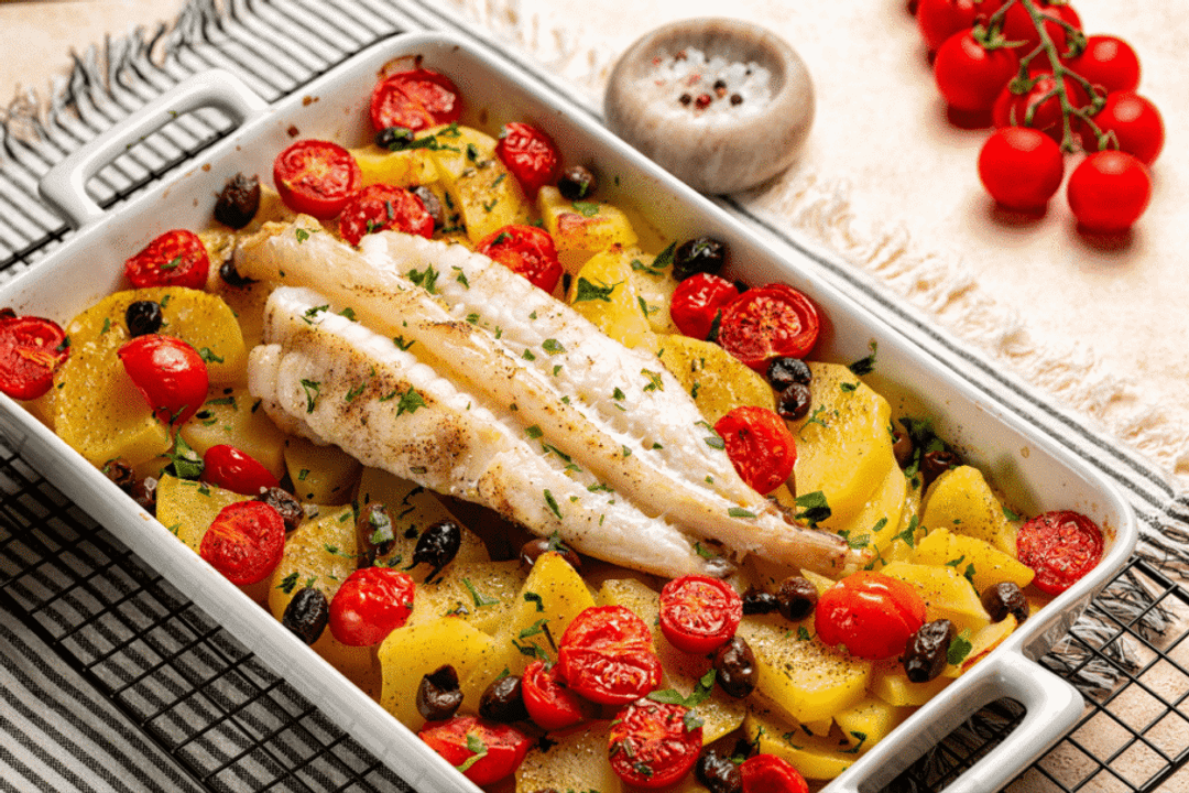 Peixe assado com batatas, tomate-cereja e azeitonas (Imagem: OlgaBombologna | Shutterstock)