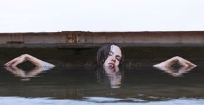 Artista faz intervenção com mulheres gigantes emergindo da água