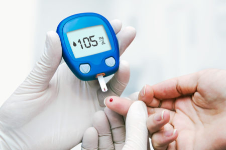 Médico fazendo teste de glicose no sangue em clínica para diabetes