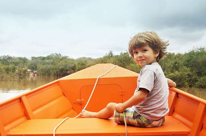 Chico passeando de barco em rio na Amazônia