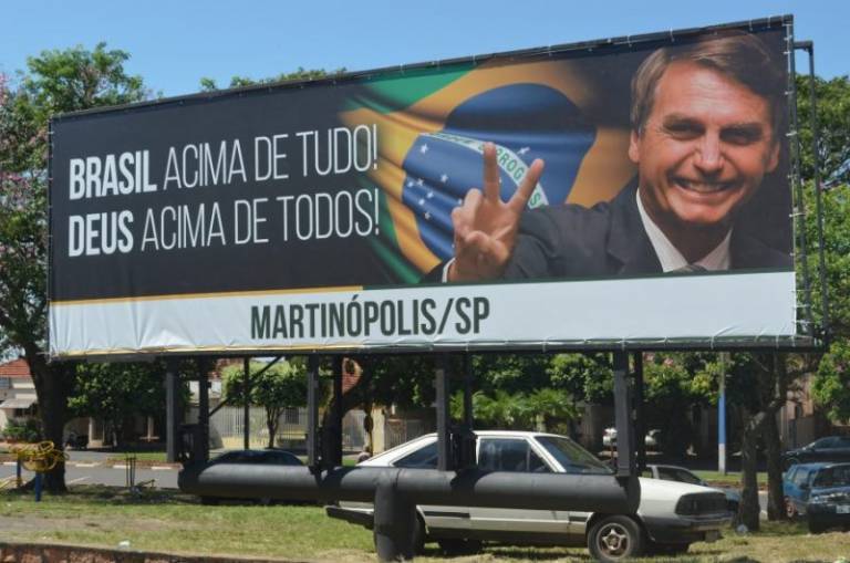 Cartaz da campanha presidencial de Bolsonaro, com frase “Brasil acima de tudo, Deus acima de todos”; slogan fazia referência ao da Alemanha nazista