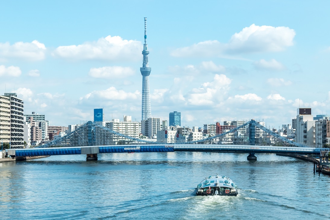 Tokyo cityscape over the Sumida River with Tokyo sky tree and Kiyosu bridge and cruise at day time, Tokyo, Japan.