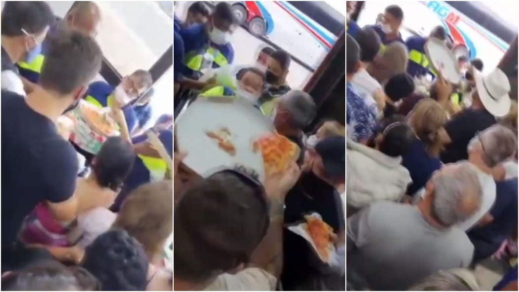 Passageiros disputam pedaço de pizza à espera de cruzeiro