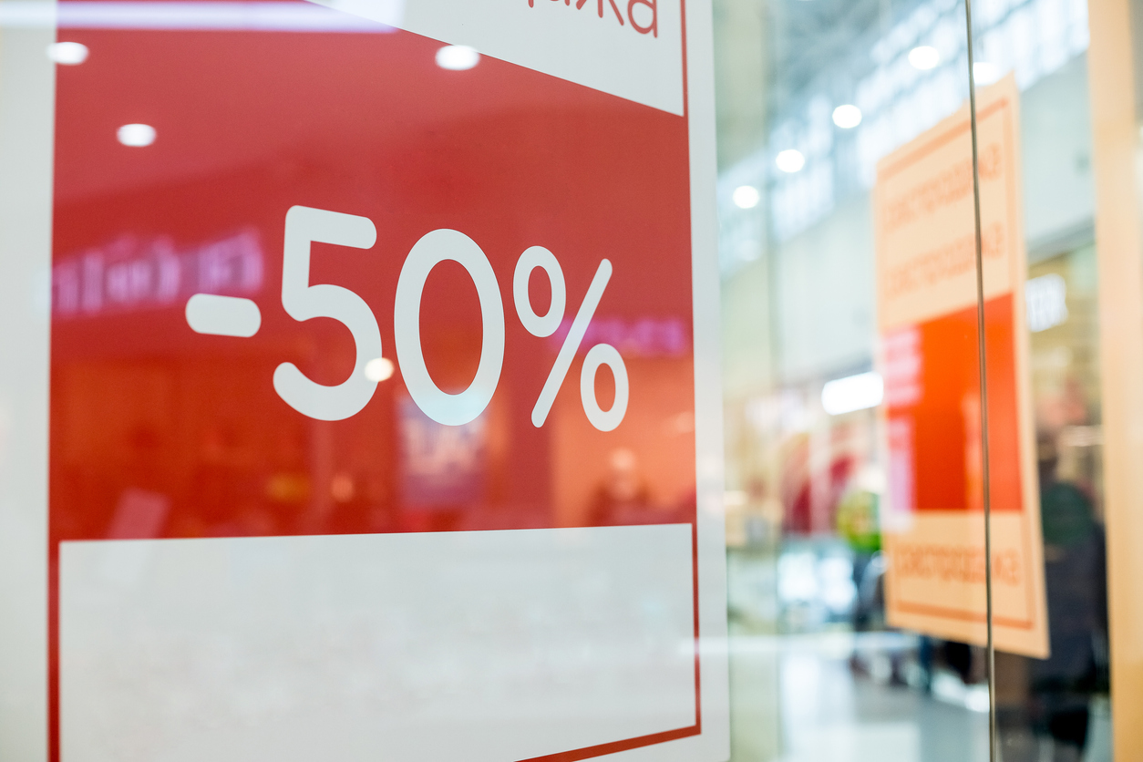 Retail Image Of A Sale Sign In A Clothing Store Window