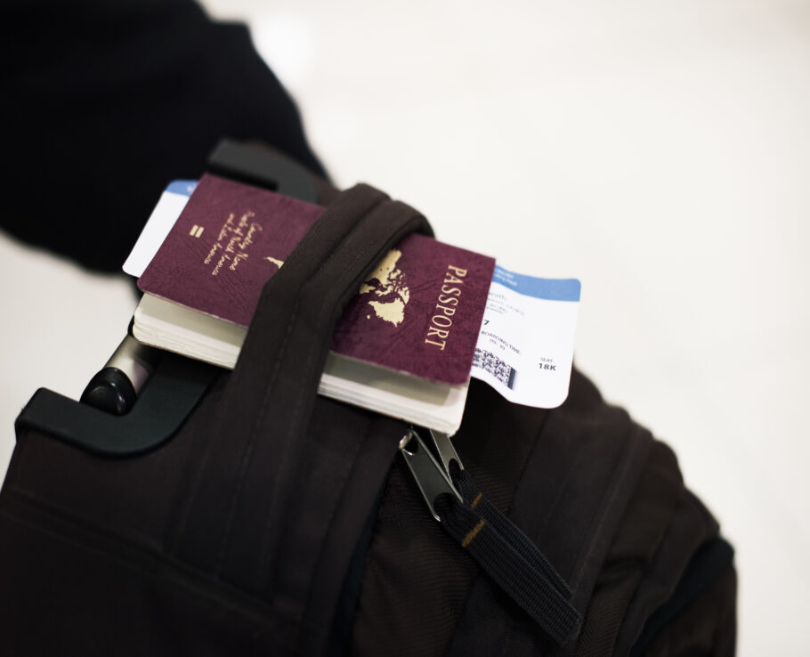 Closeup of passport with plane ticket on luggage
