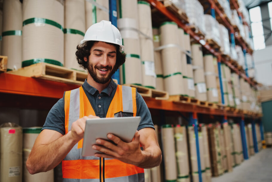 Male supervisor worker adding stock inventory data in digital tablet in warehouse