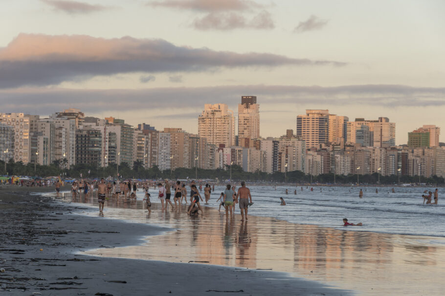 Praia do Gonzaga. Santos, Brasil. Várias pessoas aproveitando um dia de calor na praia