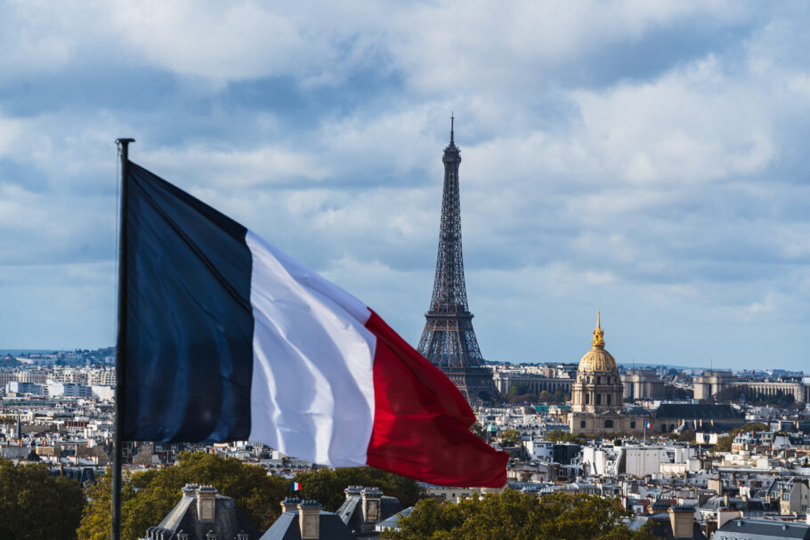 Paris skyline panorama with the Eiffel Tower and French flag