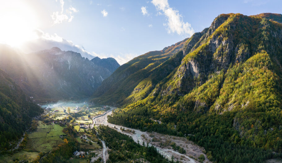 Morning over Theth village in the Northern Albanian Alps with beautiful sunbeams as the sun rises above the mountains.