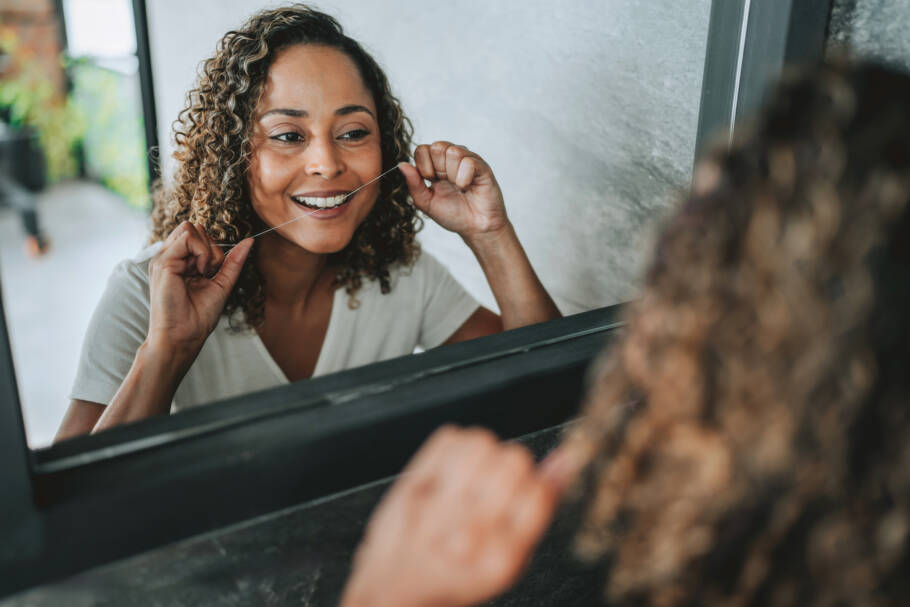 woman flossing at home