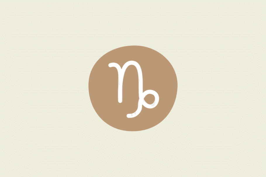 Símbolo do signo Capricórnio: traço branco de uma letra "n" cuja última haste desce e termina em um pequeno laço, dentro de uma mancha arredondada caramelo; em fundo pêssego-claro.