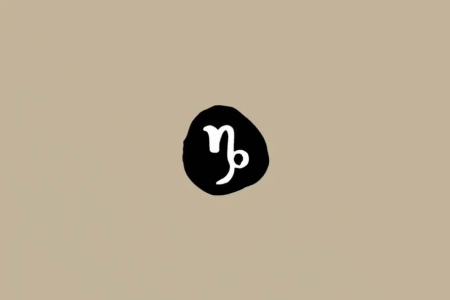 Símbolo do signo de Capricórnio em branco dentro de um círculo preto sobre um fundo bege
